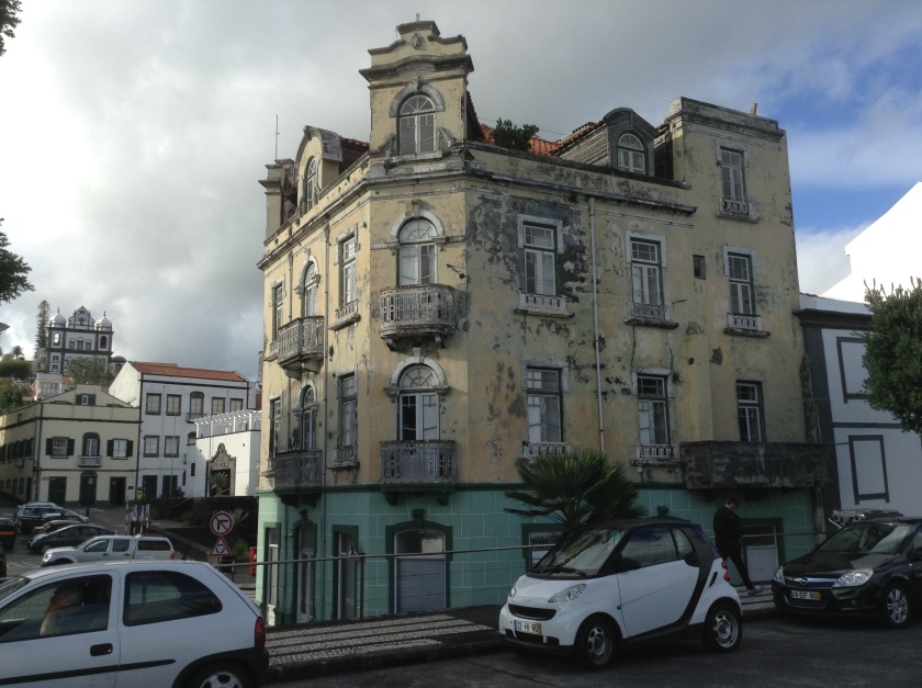 An elegant building in Horta in need of a new coat of paint.